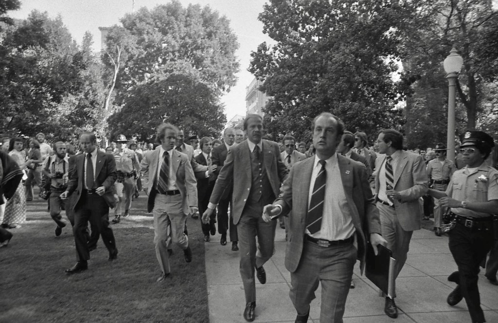 Ford being rushed by U.S. Secret Service from the site of the 1975 attempt on his life in Sacramento, California